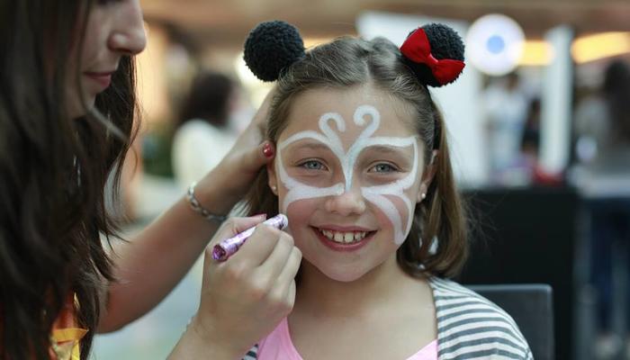 Parents and children have fun learning how to do face painting and draw on t-shirts!