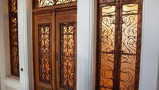 The carved patterns on the wood and metal elements blend harmoniously.