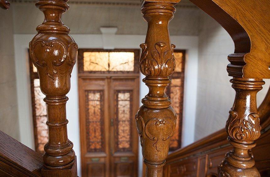 The nobility of the building is imprinted on the wooden railings.